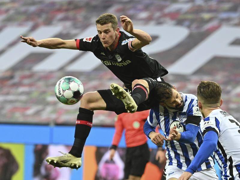 Lars Bender, seen leaping here, nearly scored late in Leverkusen's draw with Hertha Berlin.