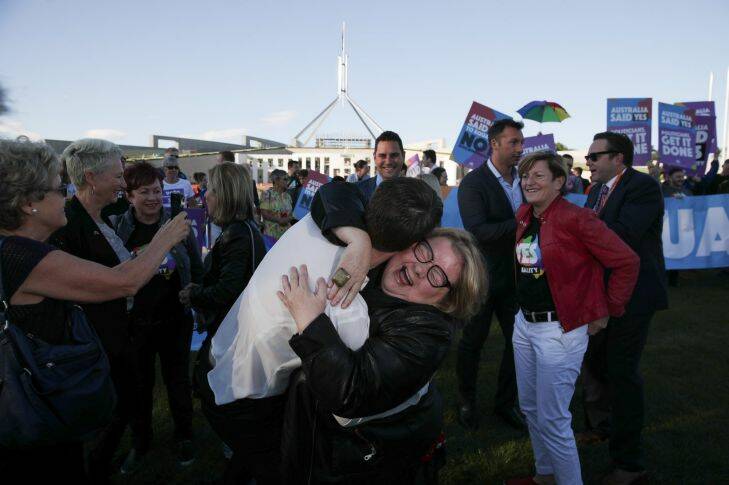 Magda Szubanski embraces Anna Brown, co-chair of the Equality campaign, during a rally on the front lawn of Parliament House ahead of the vote on the Marriage Amendment Bill, at Parliament House in Canberra on Thursday 7 December 2017. fedpol Photo: Alex Ellinghausen