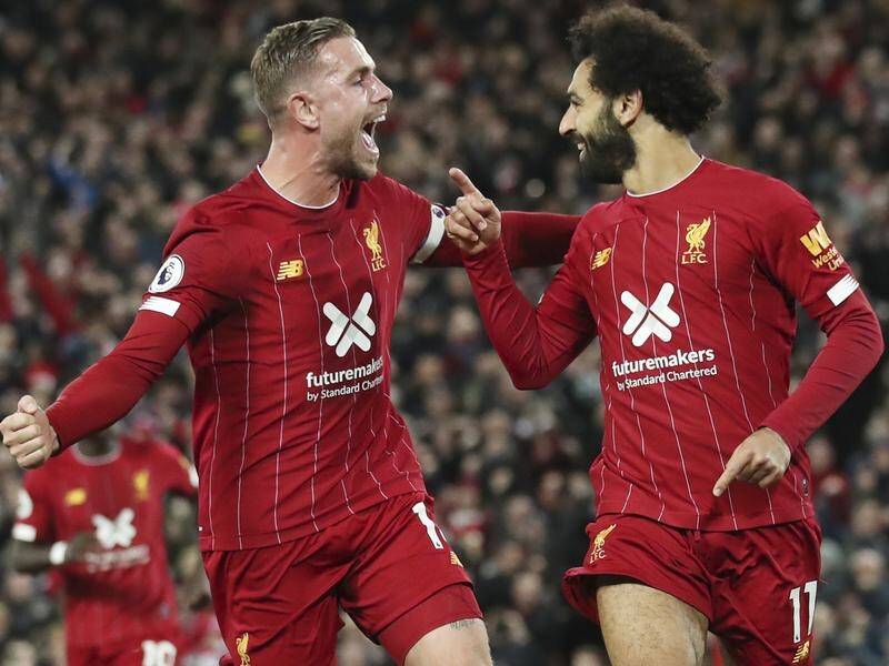 Liverpool's Mohamed Salah (r) has scored a penalty to give them a 2-1 win over Tottenham Hotspur.
