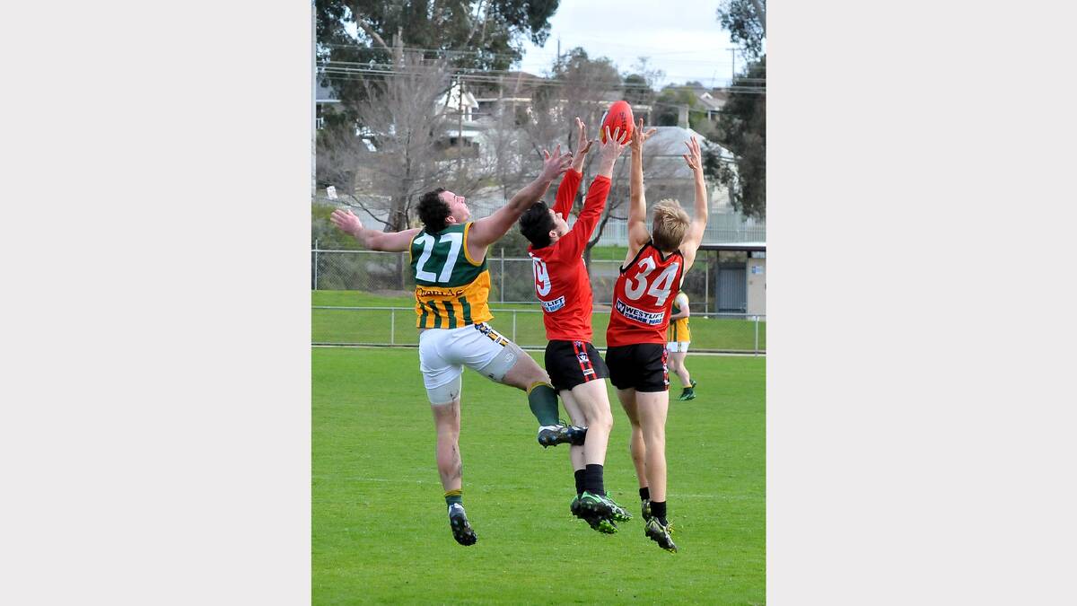Warriors defender Zac Marrow marks in betwen teammate Michael Hackwill and a Dimboola opponent on Saturday.