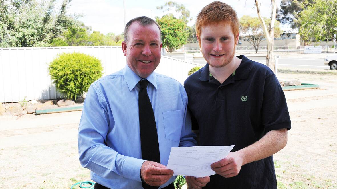 Stawell Secondary College student Michael Munro is congratulated on his tertiary offer and scholarship by acting school principal Murray Hart. Picture: BEN KIMBER