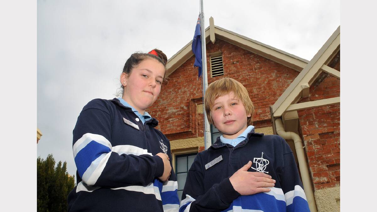 Stawell Primary School captains Kayla-Mae and Keenan join in the National Day of Mourning with their flag flying at half mast.