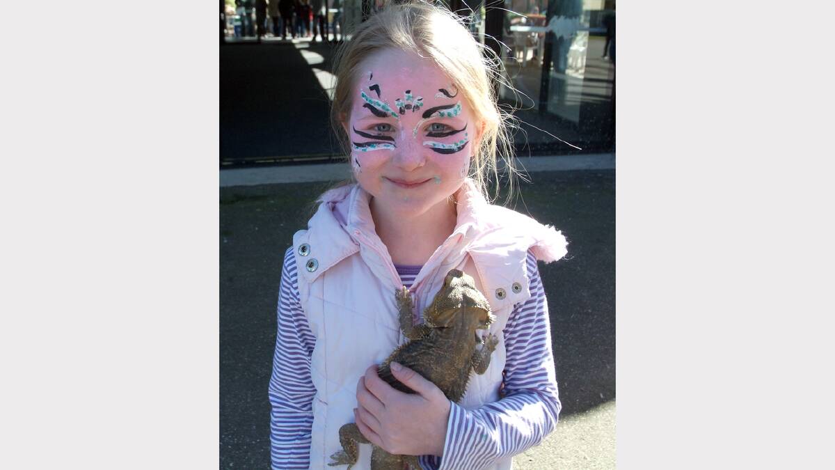 Keira of Pomonal cuddles a lizard at the Family Fun Day.