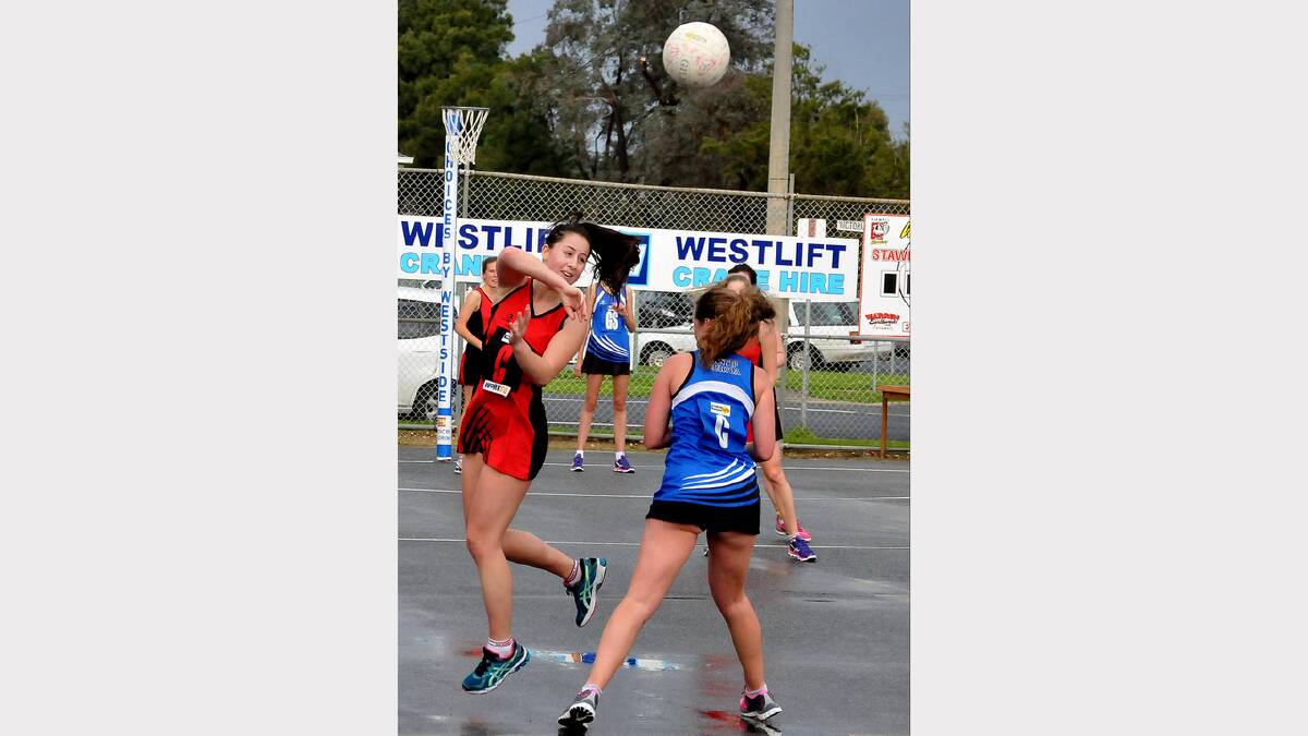 Stawell centre player Ellen Williams throws the ball high over her Minyip Murtoa opponent during Saturday's clash at Central Park.