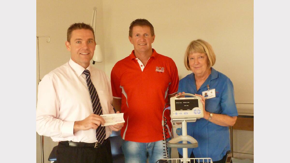 Stawell Tennis Club president Mark Stainsby, presents a cheque to former Stawell Regional Health CEO Rohan Fitzgerald and Oncology Unit Manager Jan Sherwell.