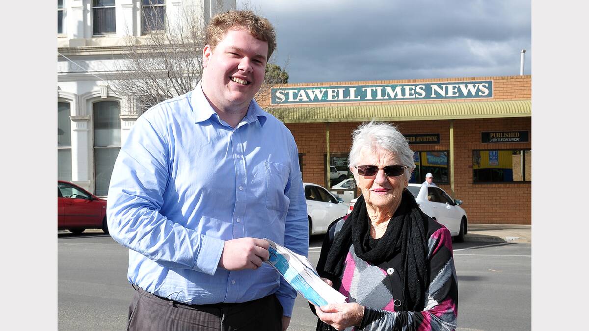 Dot McIntosh accepts her Gold Coast holiday package from Stawell Times News advertising consultant Matt Delzotto.
