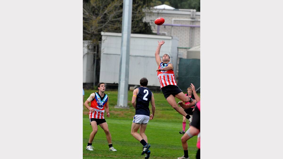 Swifts utility Ricky Whitehead soars high over his Rupanyup opponent as he attempts to take a spectacular grab during Saturday's clash at North Park.