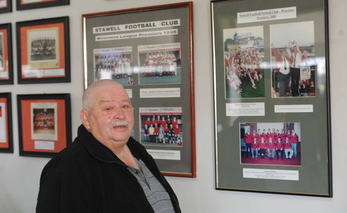 PRIDE: Robert Holmes looks back at the 2000 Stawell Warriors premiership photo. He was president of the club at the time. Picture: STUART McGUCKIN