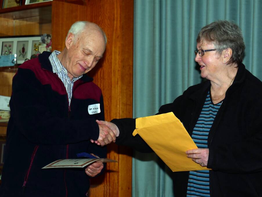 HONOUR: Stawell Camera Club President Lyn MacKenzie presents Jeff McMillan with his Victorian Association of Photographer Societies Inc Meritorious Service Award.