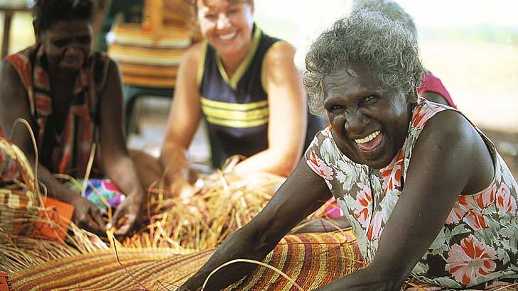 Indigenous women teach weaving.