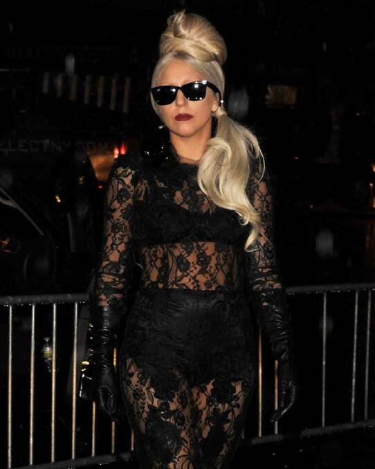 Lady Gaga, adopting the famous only-celebrities-wear-sunglasses-at-night look. An doing it pretty well.