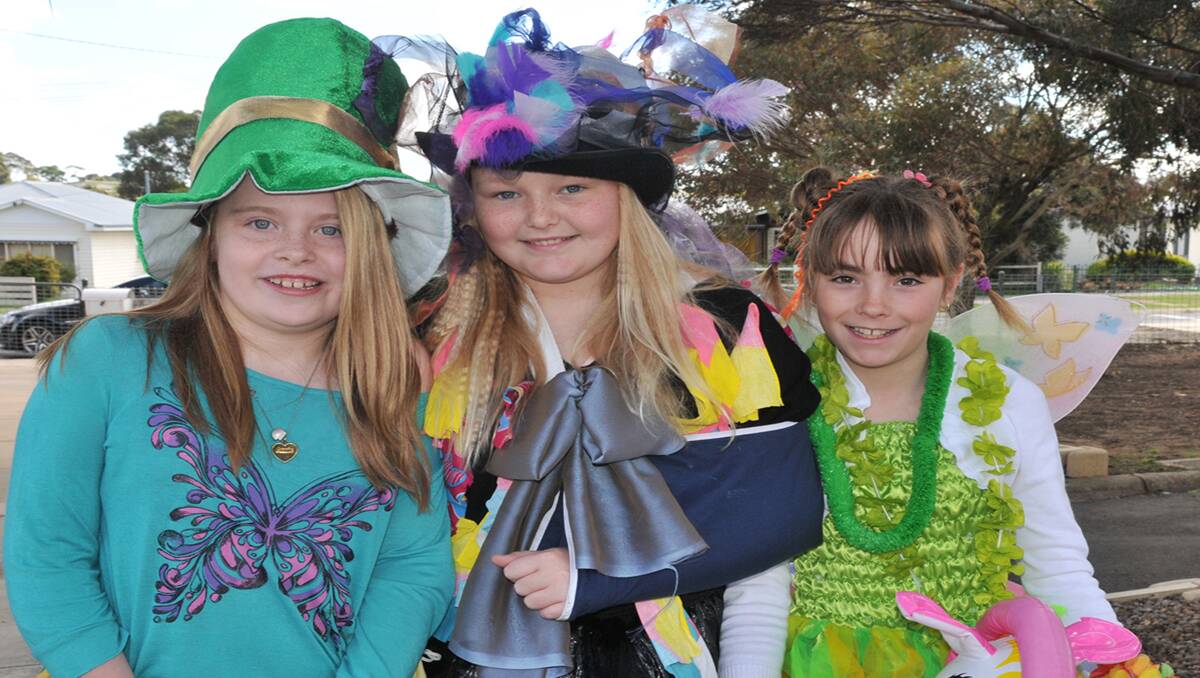 Stawell West Primary School students dressed in their fancy costumes and coloured their hair for a Crazy Friday parade, which was conducted by the School Council to raise funds for Animal Aid. Pictured in their colourful costumes are L-R Etira, Holly and Olivia. Picture: MARCUS MARROW 