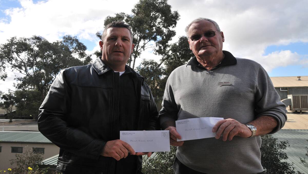Andrew Dalgleish accepts a grant for Stawell Primary School and John Welsh for the Stawell Orchid Society.