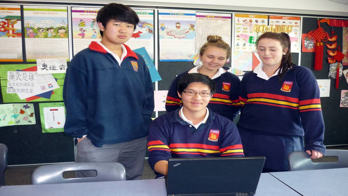 Tony, Renee and Liam look on as Cary shares his expertise in ICT at Stawell Secondary College.