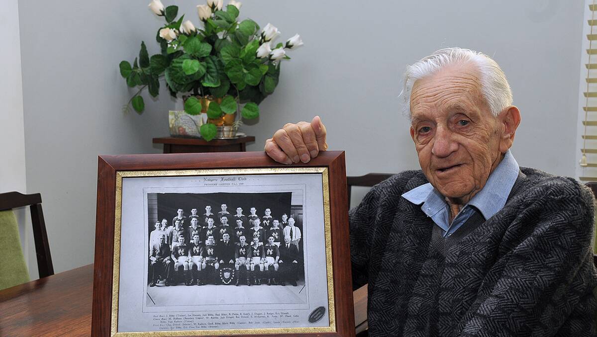 Basil Bibby with a photograph of the 1949 Navarre Football Club premiership team. Picture: KERRI KINGSTON 