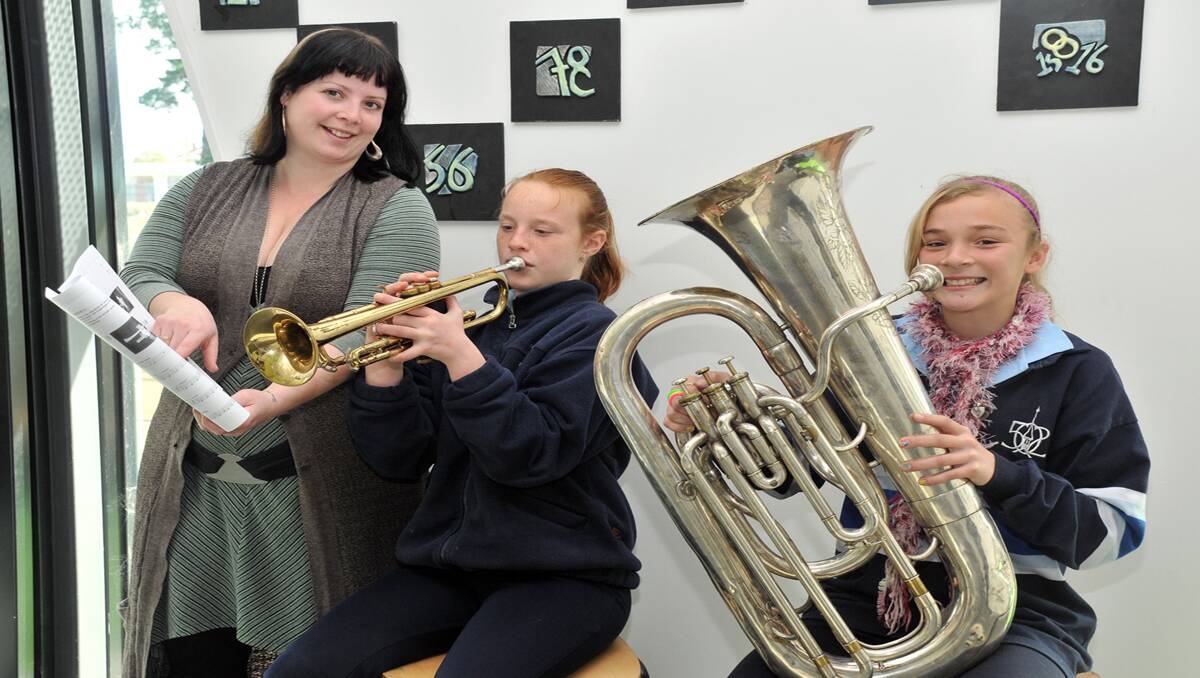Scholarships are being offered by the Stawell Brass Band to provide instrumental tutoring to interested youngsters. The idea is to try and boost membership of the Brass Band. Amelia Kingston is pictured giving instrumental lessons to students Lucy on trumpet and Chantelle on bass. Picture: KERRI KINGSTON
